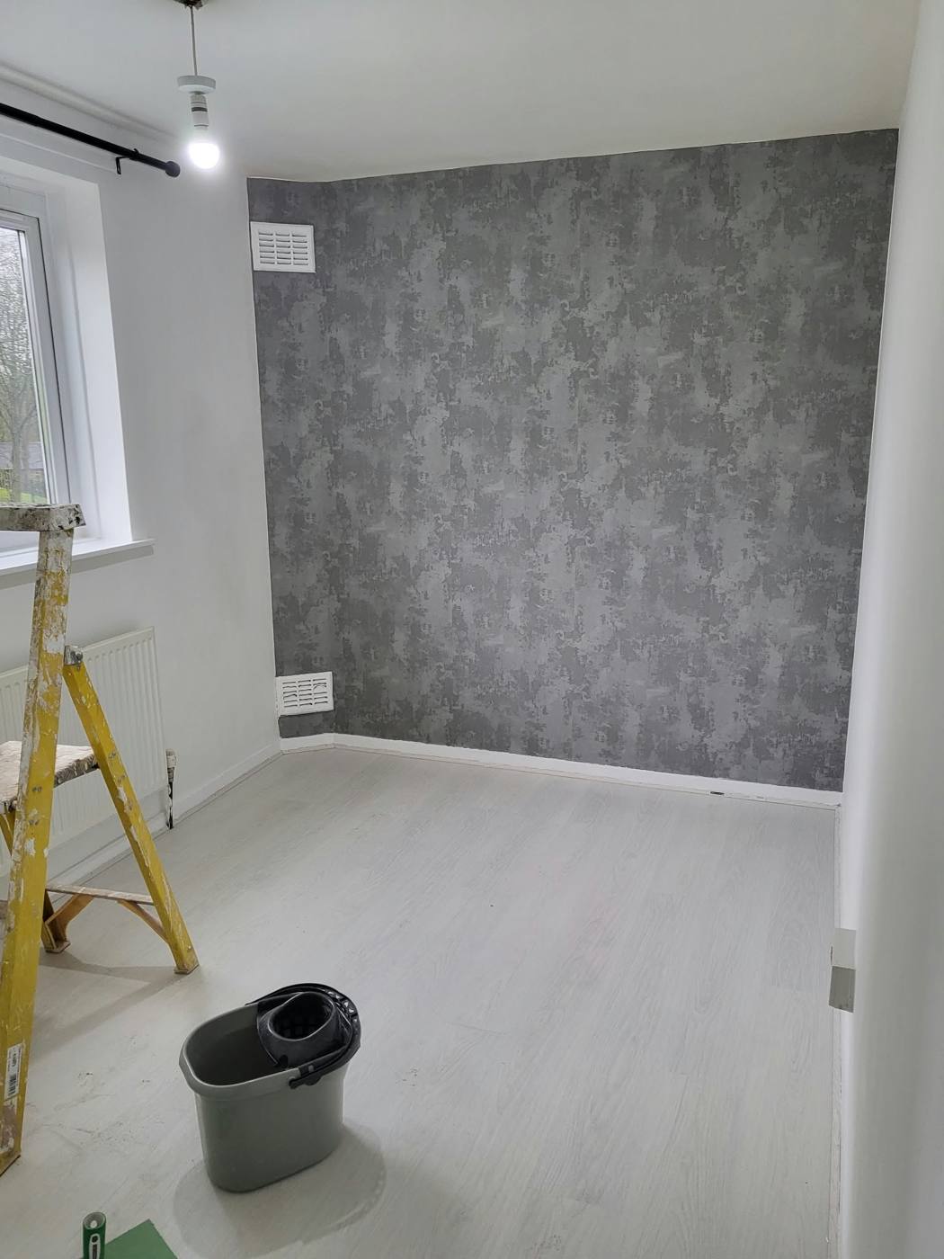 Bedroom with dark concrete-effect feature wall